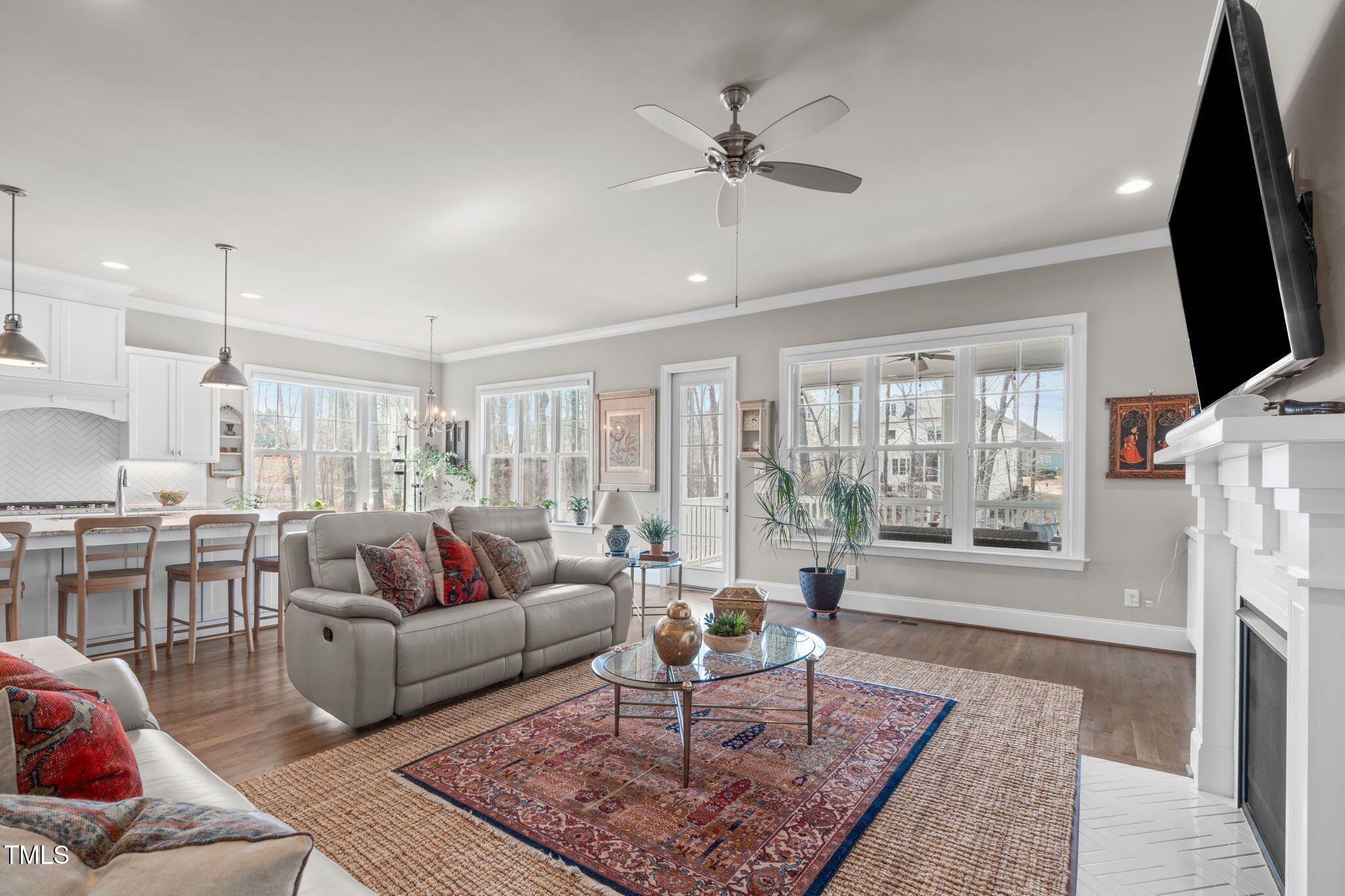 2826 Walden Road Apex, NC 27502 - Photo 13 of 50 a living room with furniture a flat screen tv and a fireplace