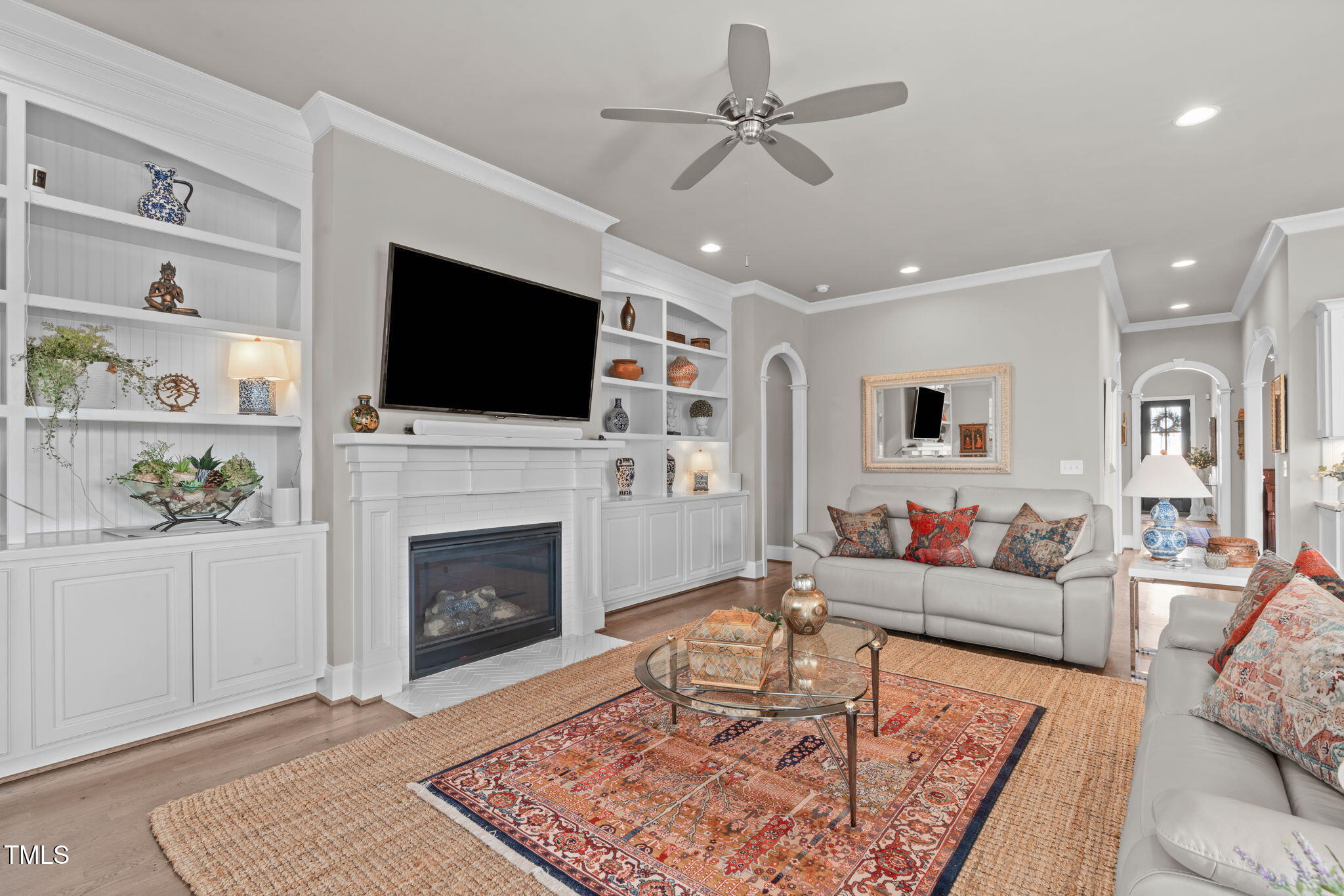 2826 Walden Road Apex, NC 27502 - Photo 15 of 50 a living room with furniture a flat screen tv and a fireplace