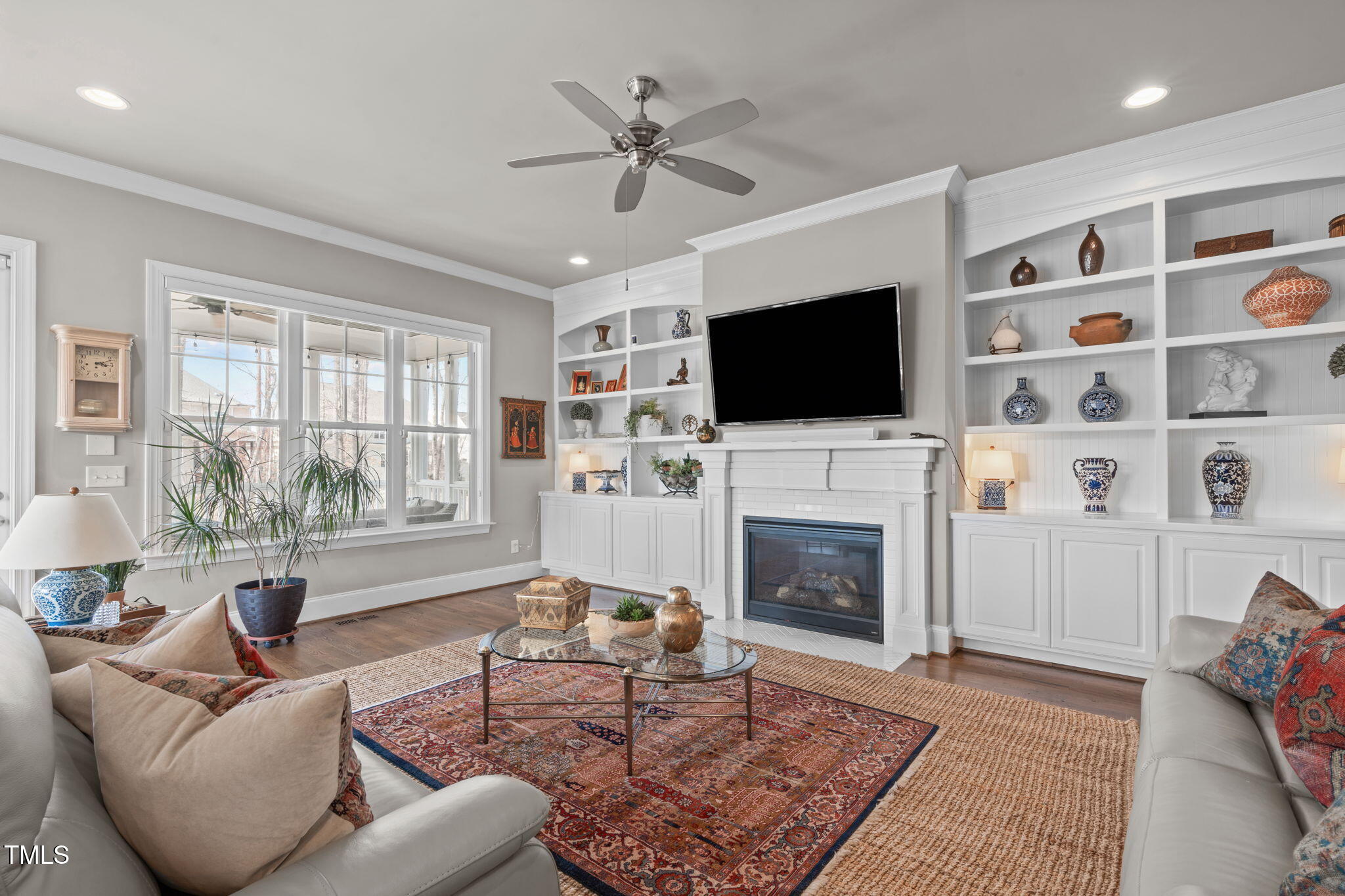 2826 Walden Road Apex, NC 27502 - Photo 17 of 50 a living room with furniture a fireplace and a flat screen tv