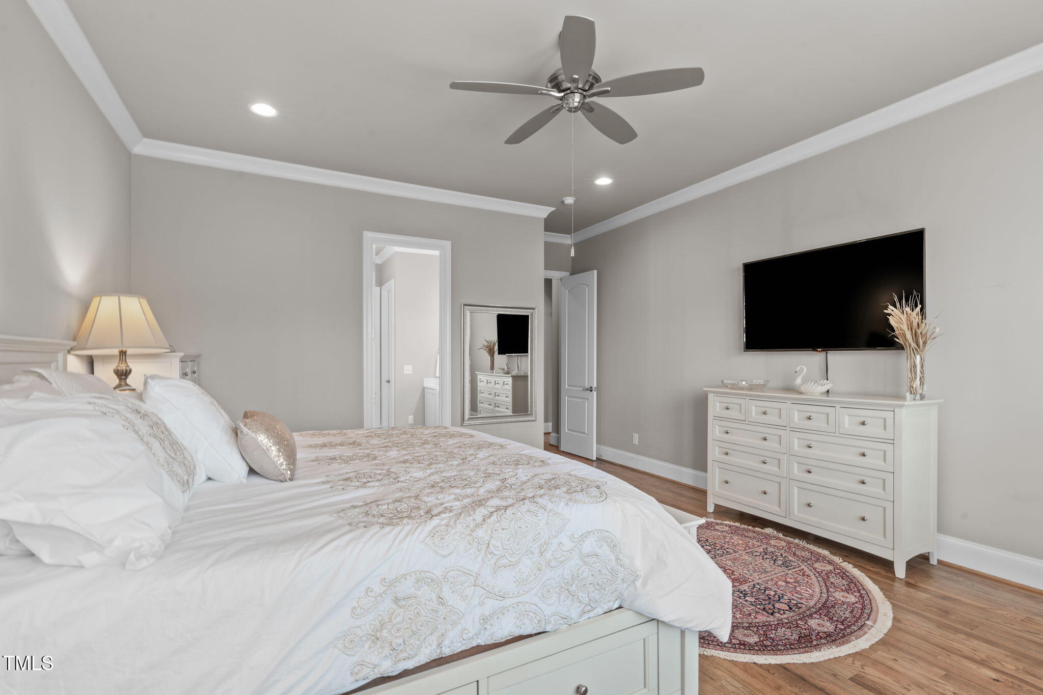 2826 Walden Road Apex, NC 27502 - Photo 22 of 50 a bedroom with a bed a flat screen tv and dresser