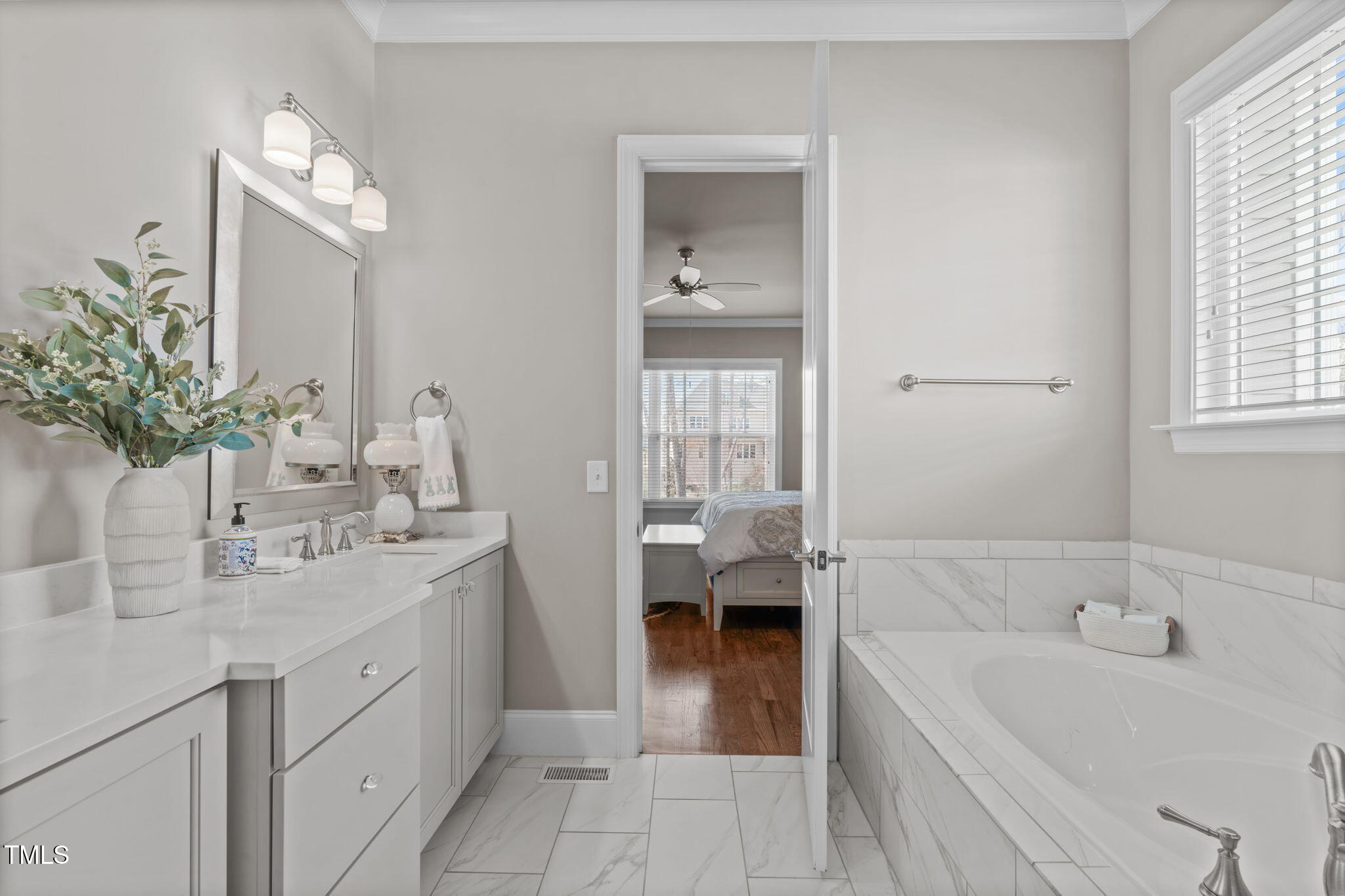 2826 Walden Road Apex, NC 27502 - Photo 26 of 50 a bathroom with a tub sink and mirror