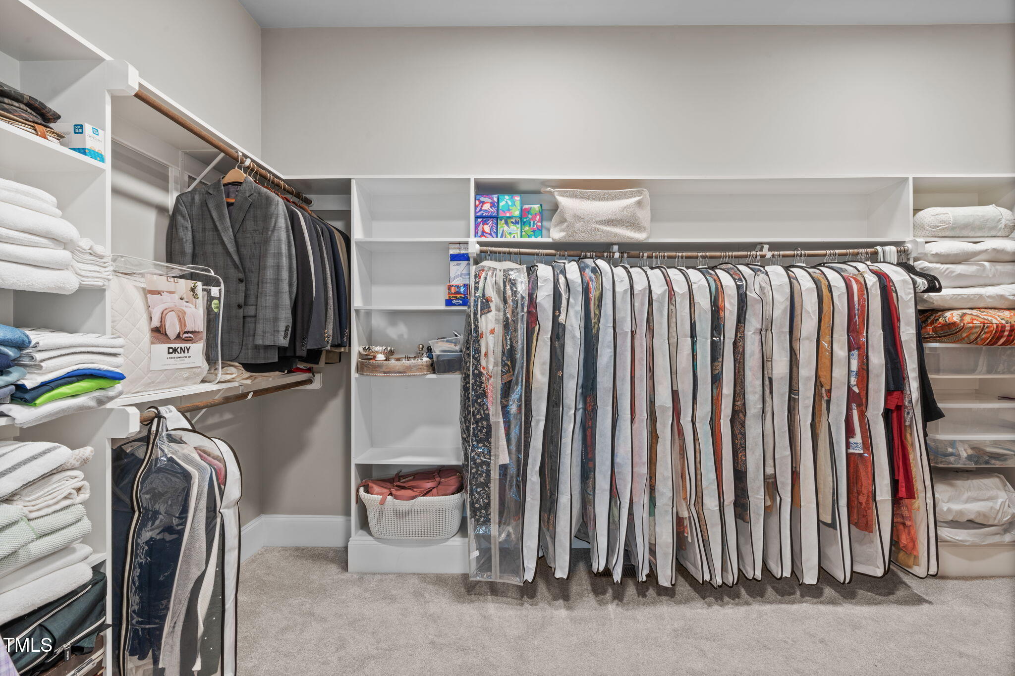 2826 Walden Road Apex, NC 27502 - Photo 27 of 50 a view of walk in closet with clothes and shoes