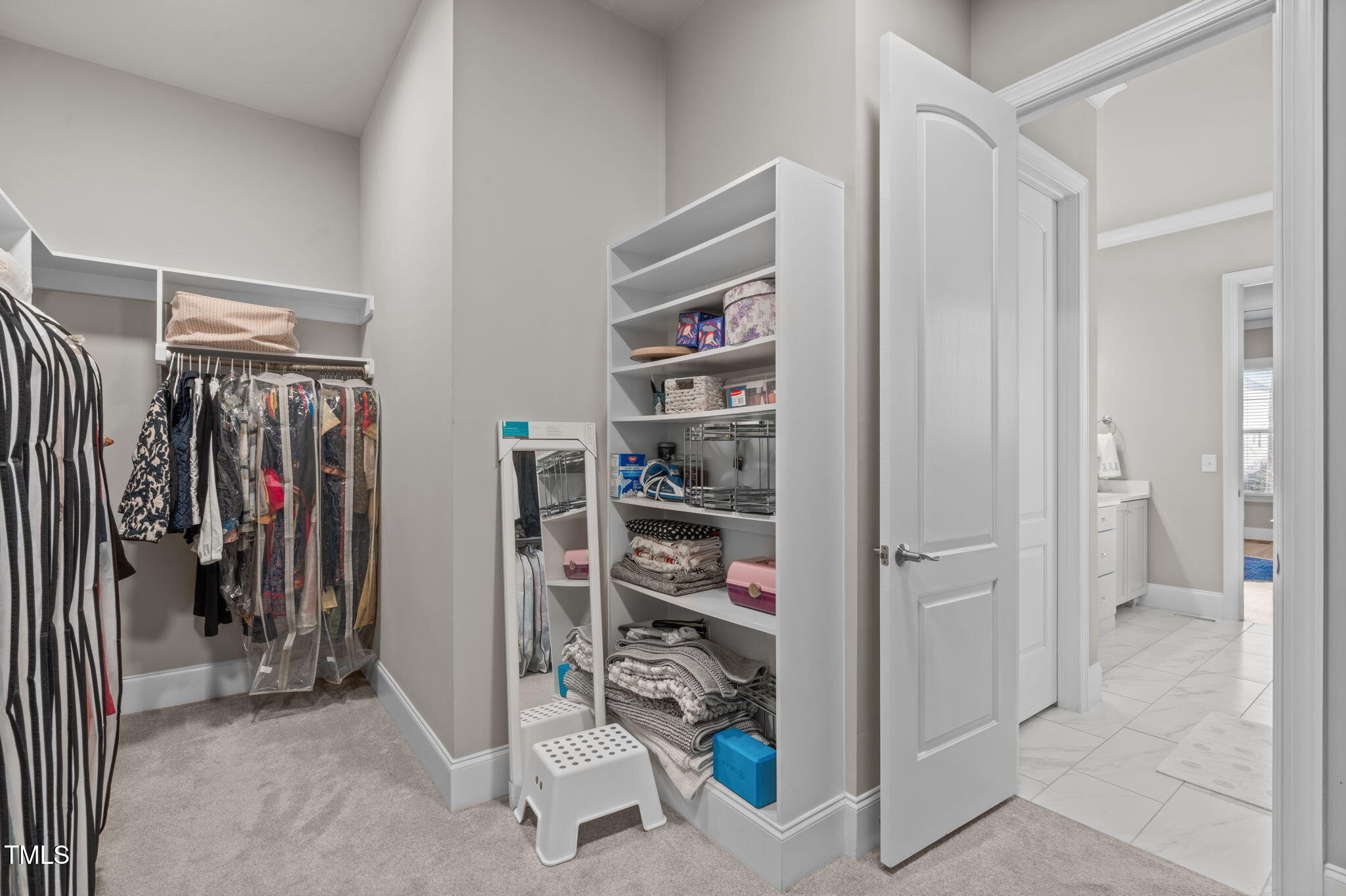 2826 Walden Road Apex, NC 27502 - Photo 28 of 50 a view of walk in closet with clothes and shoes