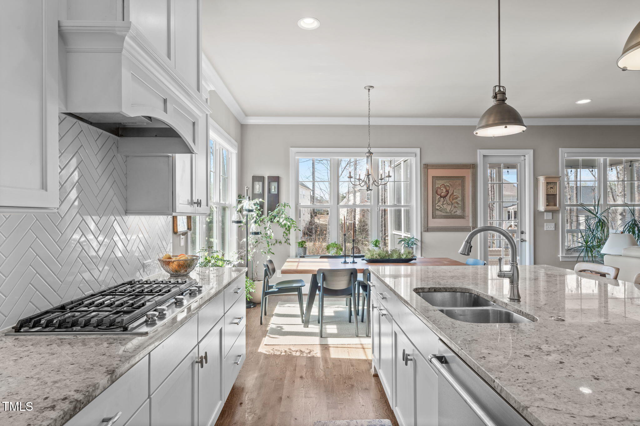 2826 Walden Road Apex, NC 27502 - Photo 8 of 50 a kitchen with granite countertop a sink a counter space appliances and cabinets
