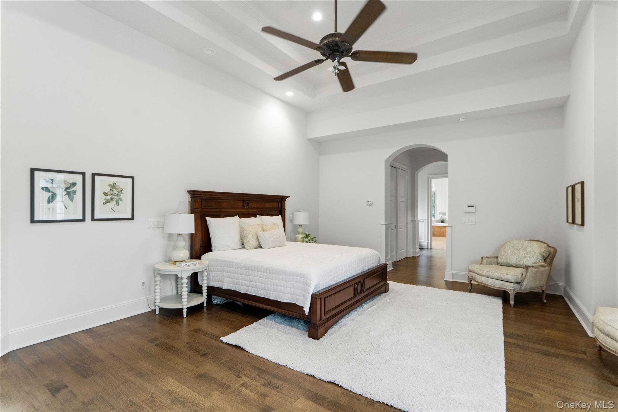 1960 Midlane Road South Syosset, NY 11791 - Photo 31 of 46 a bedroom with a bed and a chandelier