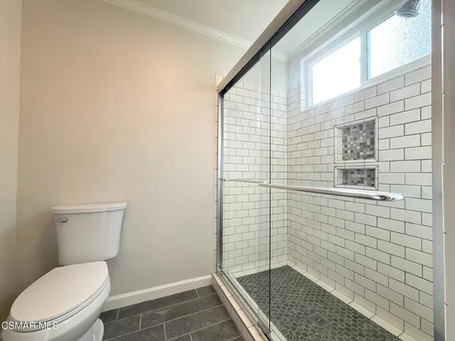 a bathroom with a toilet and a shower