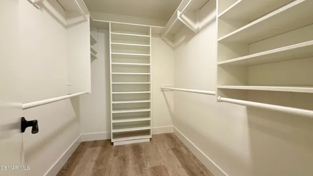 a view of walk in closet with empty racks