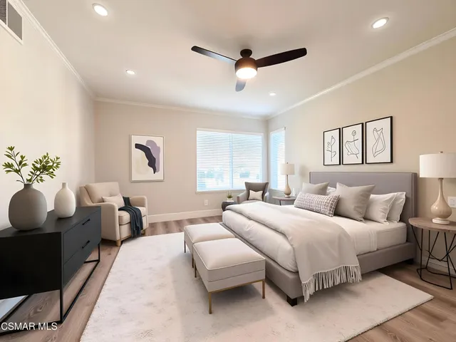 a bedroom with a bed mirror and window