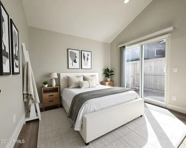 a spacious bedroom with a large bed and a large window