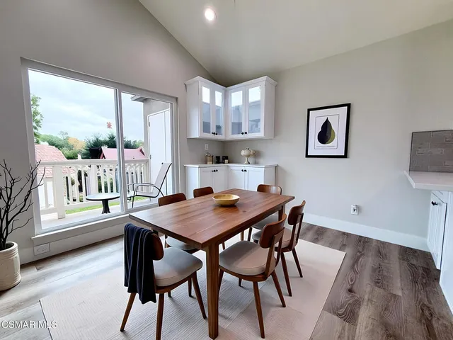 a view of a dining room with furniture and a large window