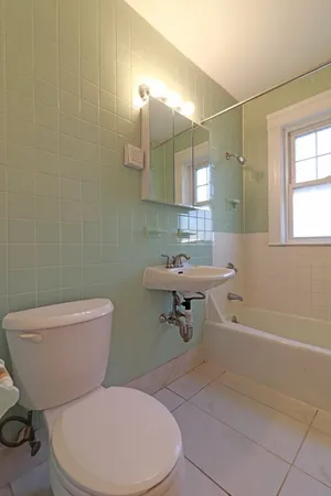 a bathroom with a sink a toilet and bathtub