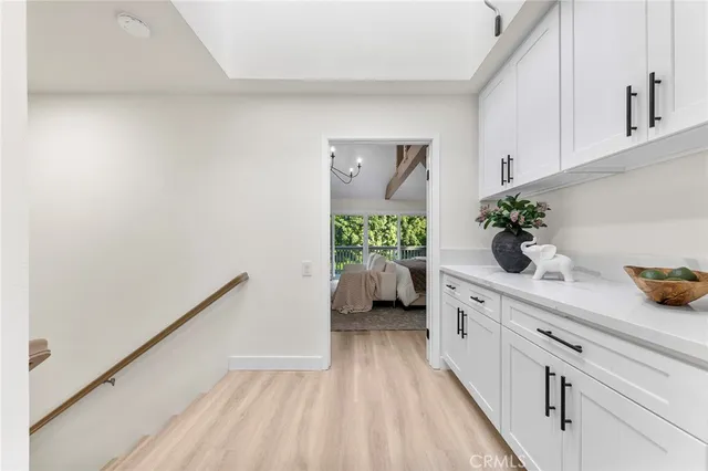 a hallway with a potted plant on the wall