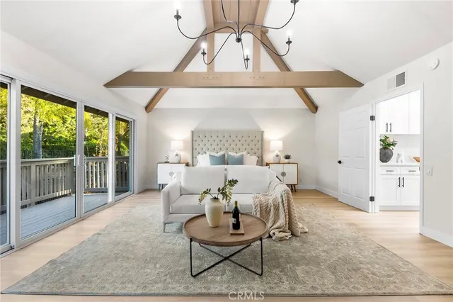 a living room with furniture and a floor to ceiling window