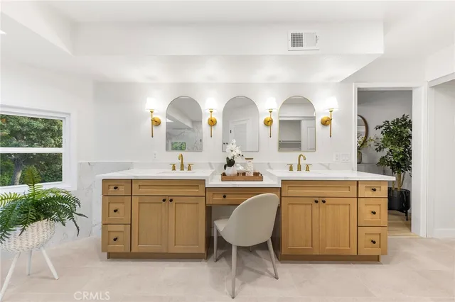 a spacious bathroom with a double vanity sink and a mirror