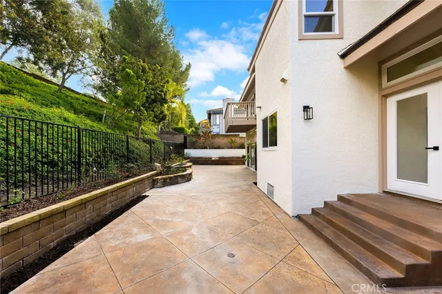 an aerial view of a house with swimming pool and garden