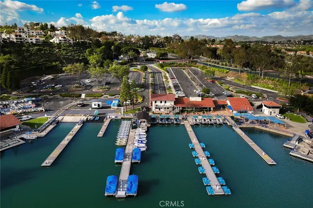 an aerial view of a house with yard and lake view