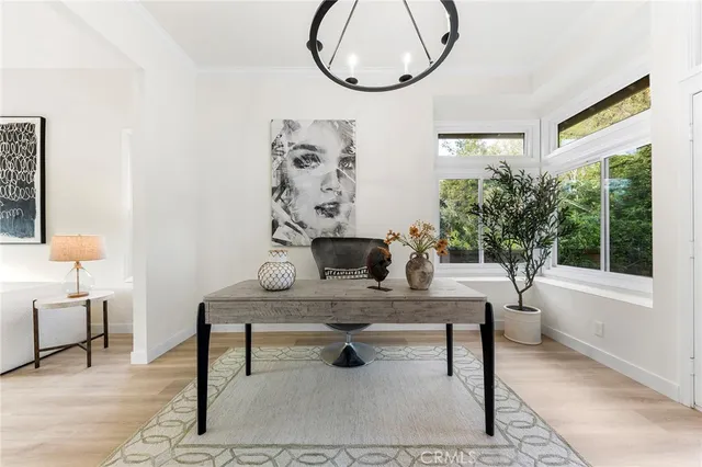 a living room with furniture a table and a large window