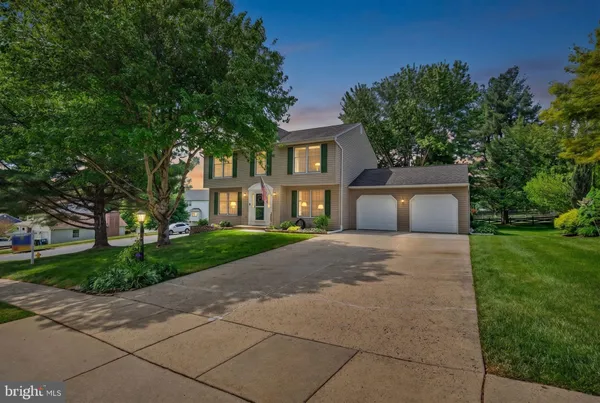 a front view of a house with a yard and a garage