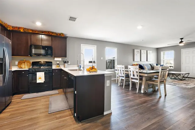 a kitchen with lots of counter top space and stainless steel appliances