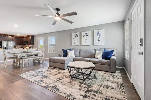 a living room with furniture and kitchen view