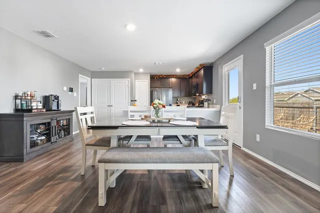 a view of kitchen with cabinets table and chairs
