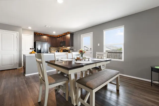 a view of a dining room with furniture window and wooden floor