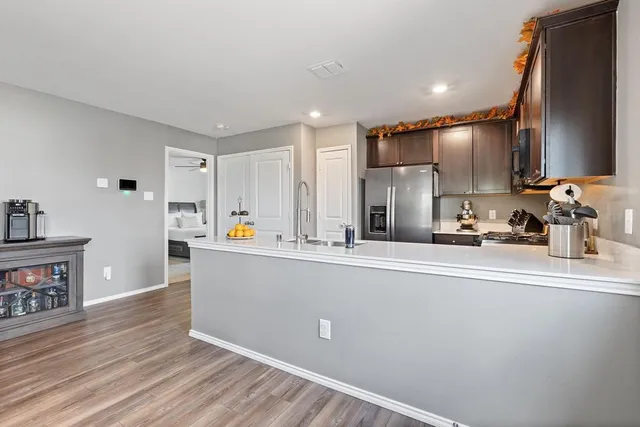 a kitchen with stainless steel appliances a refrigerator and a stove top oven