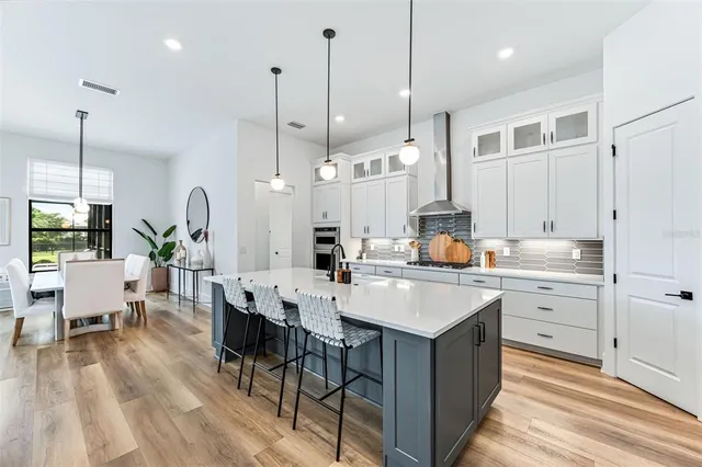 a kitchen with a sink a center island a counter space and living room view