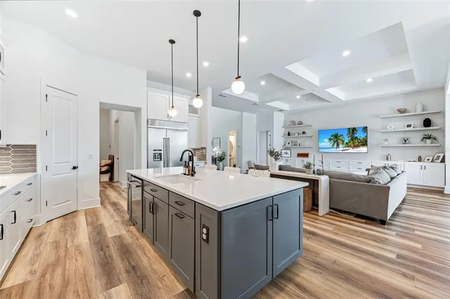 a bedroom with a bed and a flat tv screen on dresser