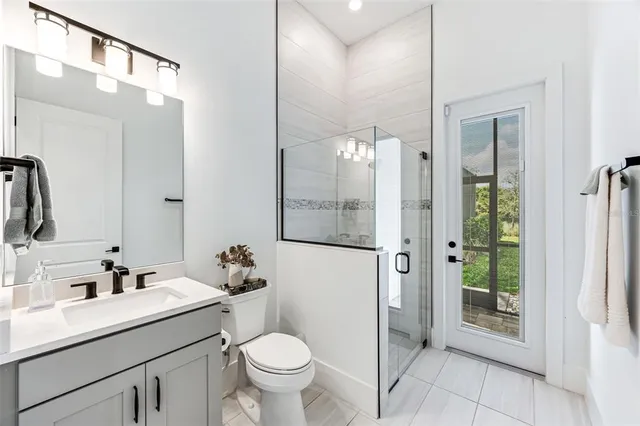 a bedroom with furniture and a large window