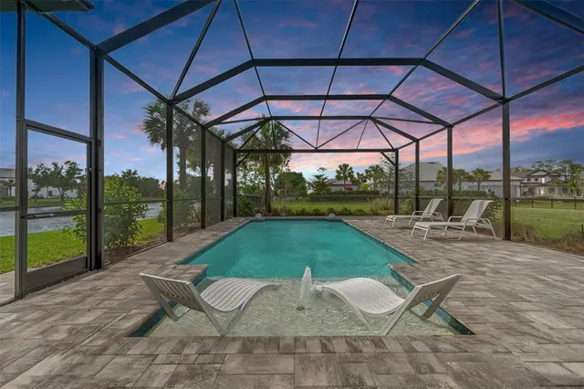 a patio with a table and chairs under an umbrella