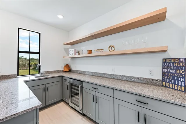 a living room with furniture a floor to ceiling window and potted plant