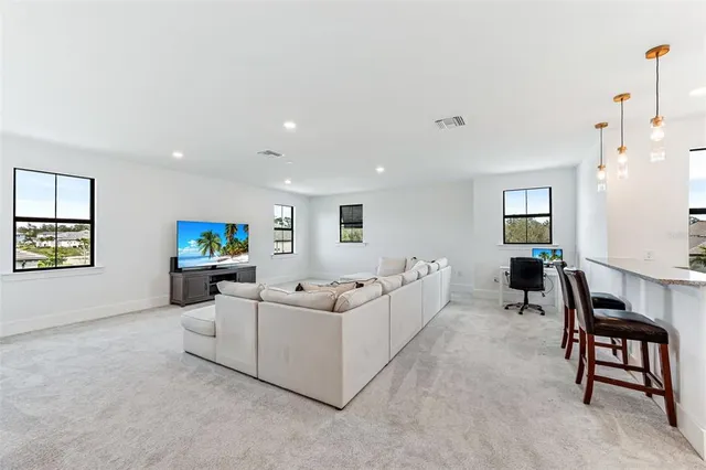 a open dining room with furniture a floor to ceiling window and a fireplace