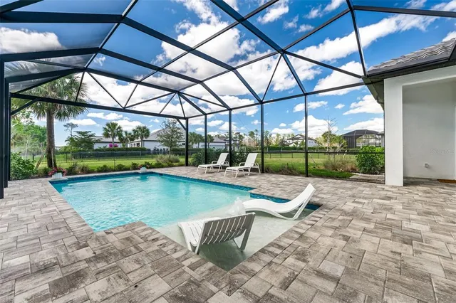 an aerial view of a house with a garden and lake view