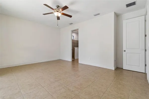 a living room with furniture a flat screen tv and a large window