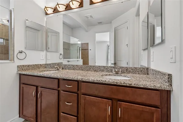 an empty room with chandelier fan