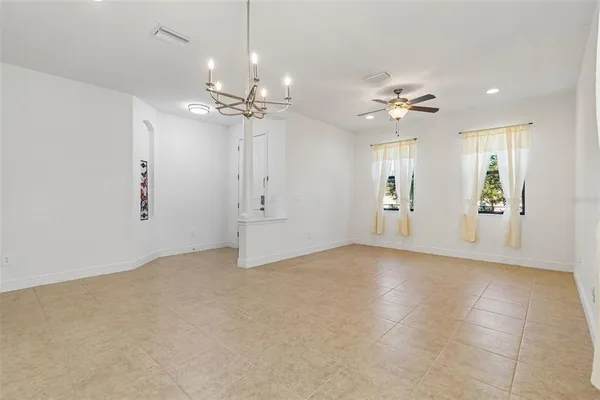 a view of an empty room with window and cabinet