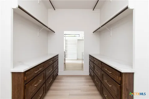 a hallway with cabinets and wooden floor