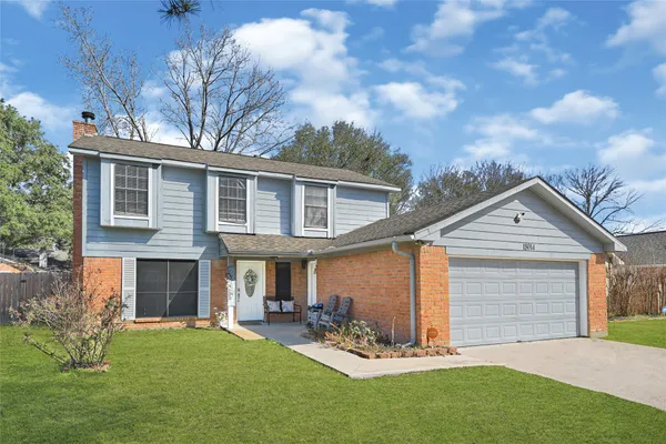 a view of a house with a yard and sitting area