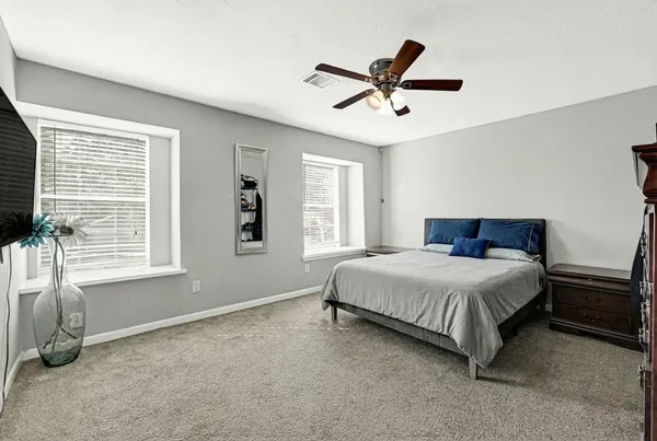 a bedroom with a large bed and a window