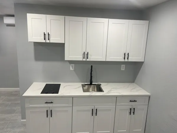a kitchen with a sink and cabinets