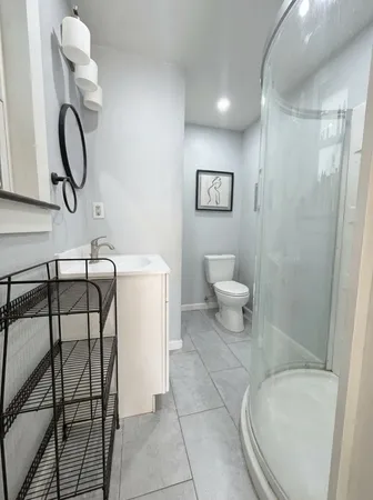 a bathroom with a toilet and a shower