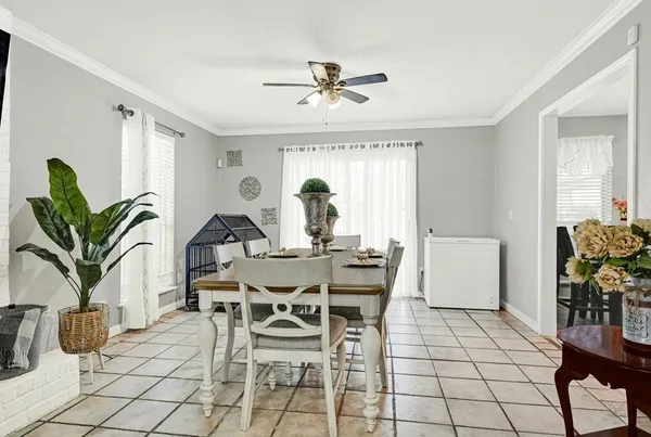 a view of a dining room with furniture window and flowerpot