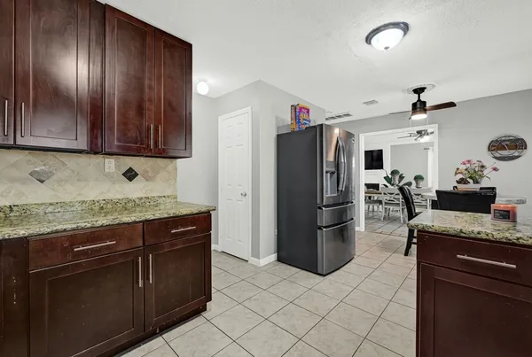 a kitchen with a refrigerator and microwave
