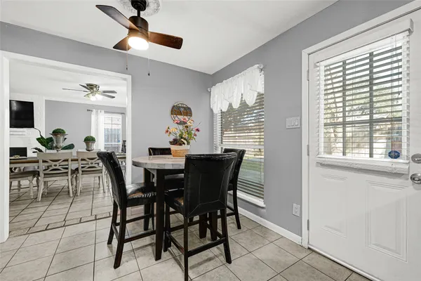 a view of a dining room with furniture and a window