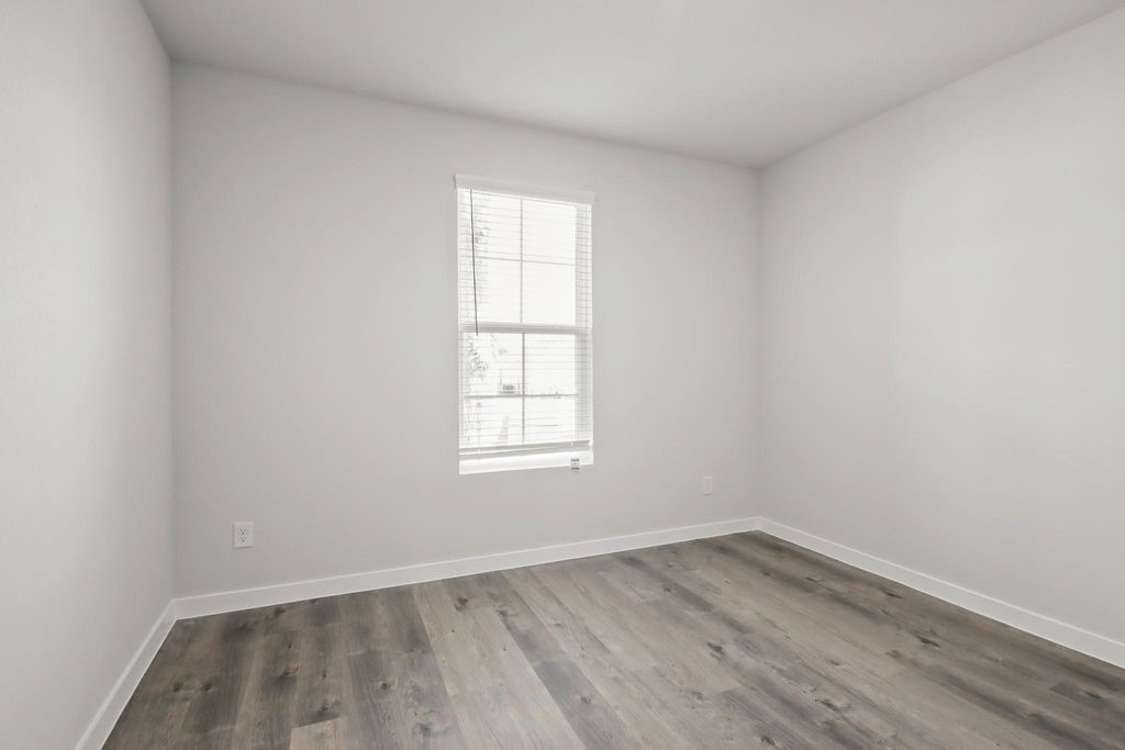 496 Shoreview Drive Conroe, TX 77303 - Photo 11 of 20 an empty room with wooden floor and window