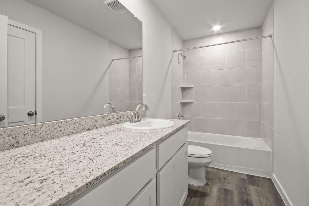 496 Shoreview Drive Conroe, TX 77303 - Photo 15 of 20 a bathroom with a granite countertop sink a toilet and shower