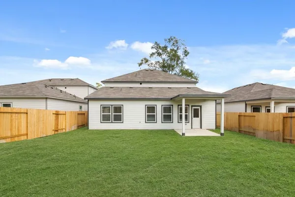 a front view of a house with a garden and yard