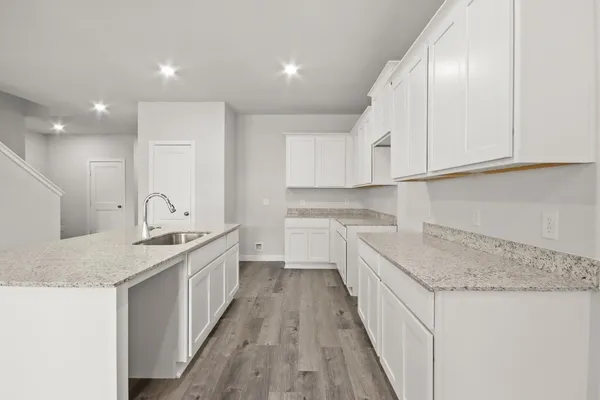 a kitchen with a sink stove and cabinets