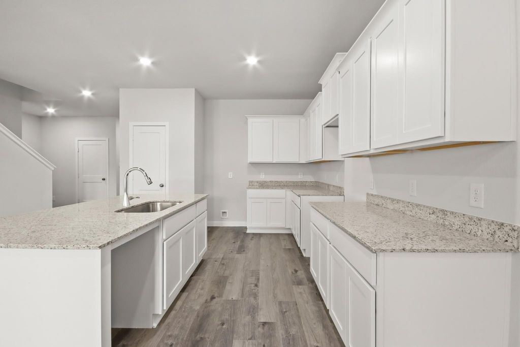 496 Shoreview Drive Conroe, TX 77303 - Photo 3 of 20 a kitchen with a sink stove and cabinets